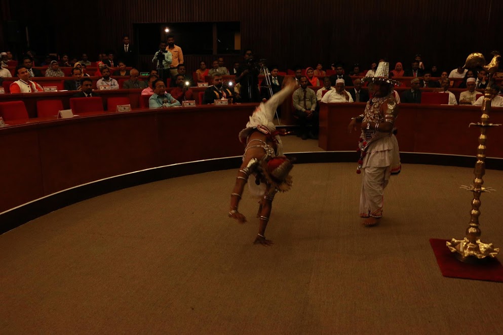 Kandyan dancers performing for the delegates at the International Peace Conference, Colombo — one mid-handstand before the seated audience